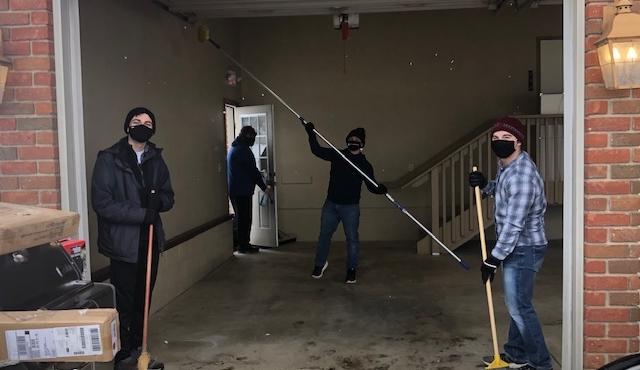 students cleaning garage